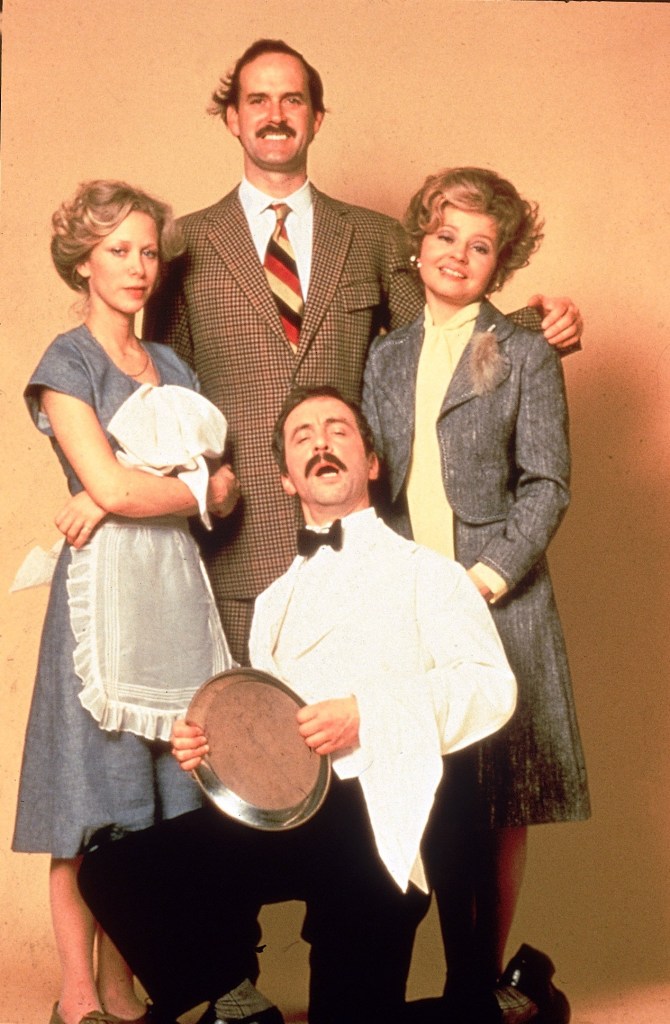 Connie Booth as Polly, JOHN CLEESE as Basil Fawlty, PRUNELLA SCALES as Sybil Fawlty, ANDREW SACHS (kneeling) as Manuel, Andrew Sachs