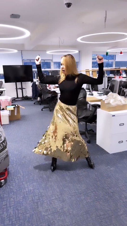 Amanda Holden showing off a sequin gold skirt.